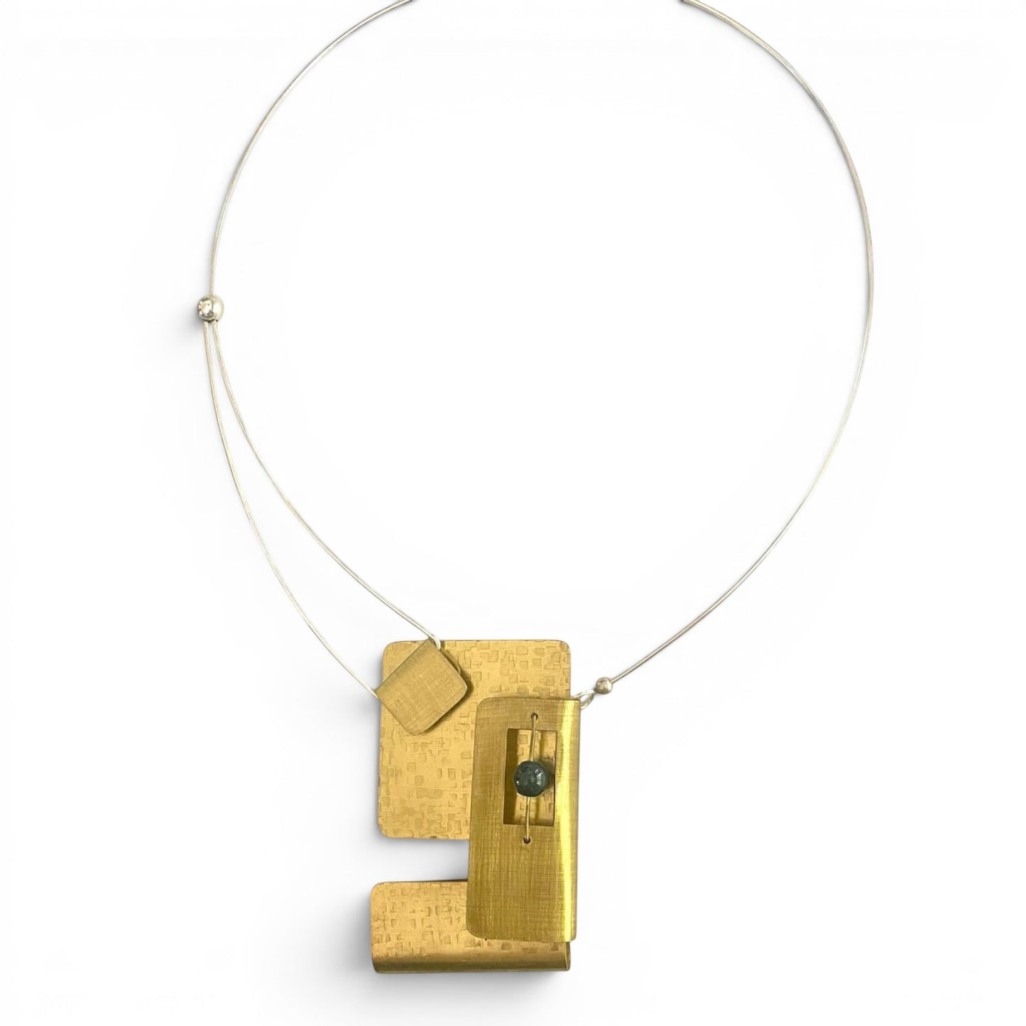 Chick Boss statement necklace with overlapping brass rectangles and a jade accent bead. Textured metal.