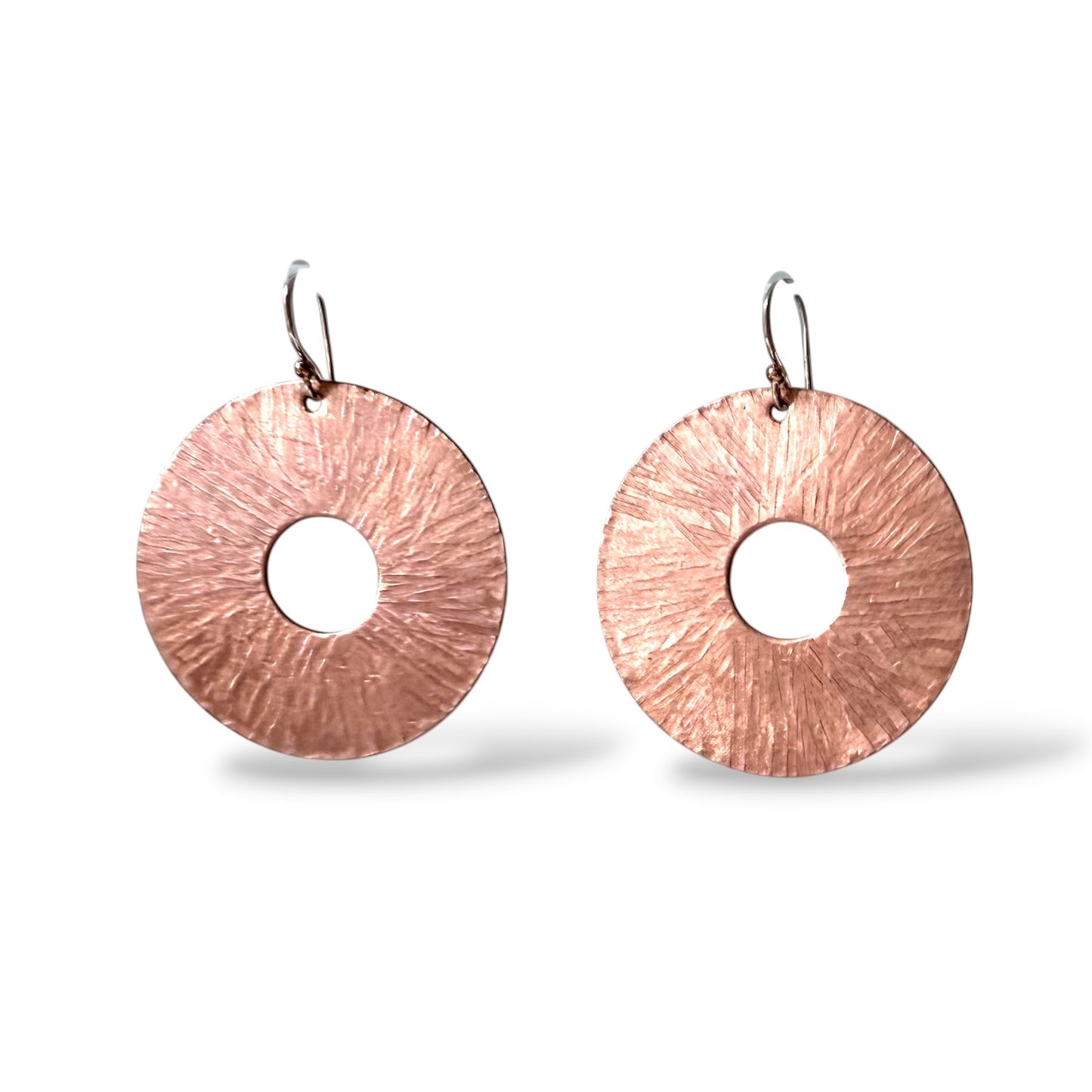 Chick Boss copper disc earrings with a textured, sunburst design and sterling silver ear wires.