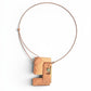 Chick Boss statement necklace with overlapping copper rectangles and a jade accent bead. Textured metal.