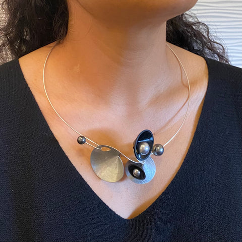 VOLUME 3 Multi-Directional Amplification Cones are at the Center of this Necklace from the SOUND Collection with Recycled Record Vinyl and Simulated Pearls